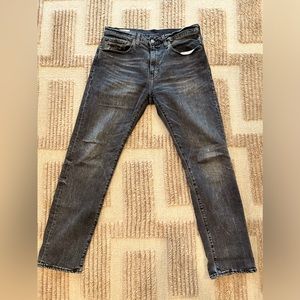 Faded black Levi’s 502 jeans.